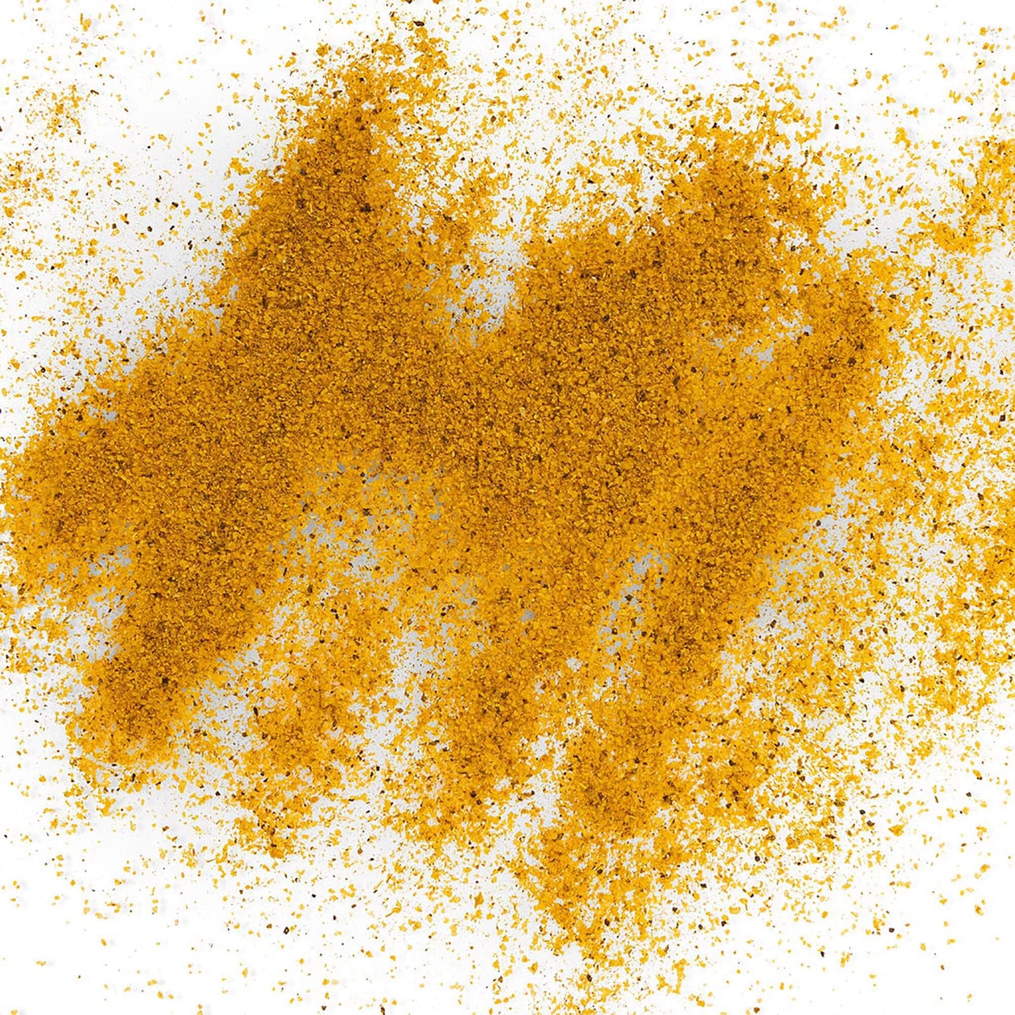 Loose Healthy Rican Adobo seasoning scattered on a white surface with golden Puerto Rican spices.