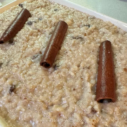 Arroz con Dulce, a traditional Puerto Rican coconut rice pudding topped with cinnamon sticks and served as a favorite holiday dessert.