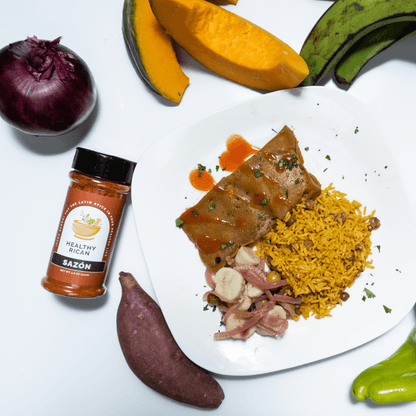 Healthy Rican Sazón seasoning beside Puerto Rican rice, fish, and root vegetables with pumpkin, plantain, and onion.