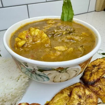 Sancocho with tender meat, corn, plantains, and root vegetables in a hearty Puerto Rican stew, served with white rice and fried plantains.
